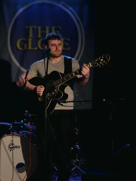 Martin Purvis performing live with an acoustic guitar